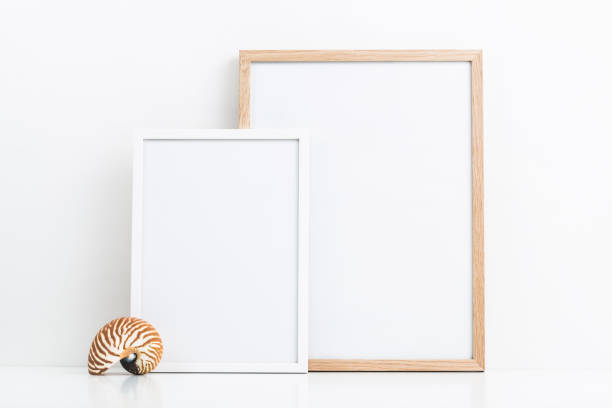 minimal ocean, beach house or summer themed mockup with two photo frames and a decorative nautilus shell on a white table, clipping path included, sizes: 30 x 40 cm, 21 x 30 cm