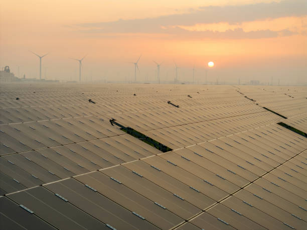 istock Solar power station and wind power station at sunrise 2168595719