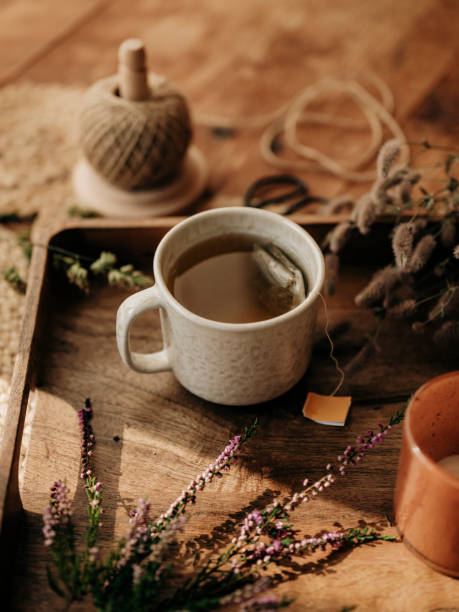 istock Autum tea cup still life with heather and hares foot clover 2168597573