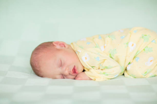 istock Little baby on white bed 2168598275