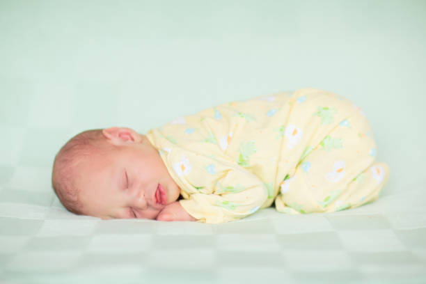 istock Little baby on white bed 2168598427