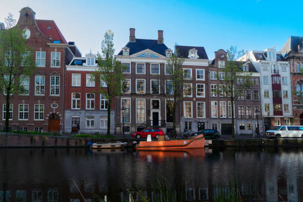 Facades of old historic Houses over canal water, Amsterdam, Netherlands