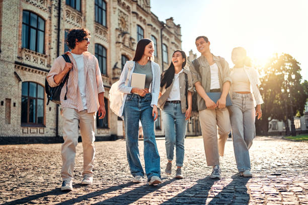 istock A group of beautiful successful confident modern students are walking on the campus, chatting and laughing. Education and college studies. 2168603156