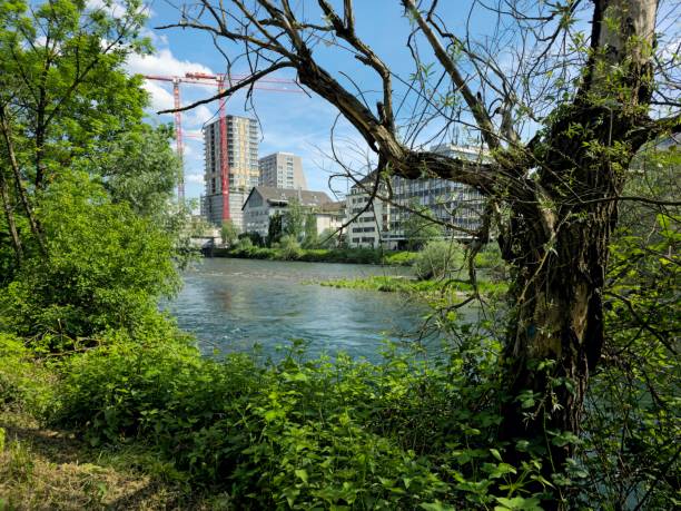 Limmat riverside with several residential buildings. The image shows the Zurich district 5 (industry) with a construction site captured during a sunny day in spring season.