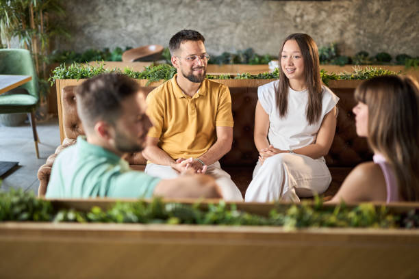 istock Group of happy couples talking while having a social gathering in a cafe 2168606541