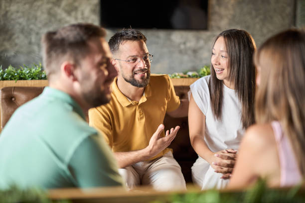 Happy couples enjoying in conversation during a social gathering in a cafe