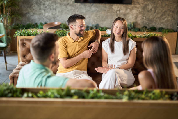 istock Group of happy couples talking while having a social gathering in a cafe 2168606633