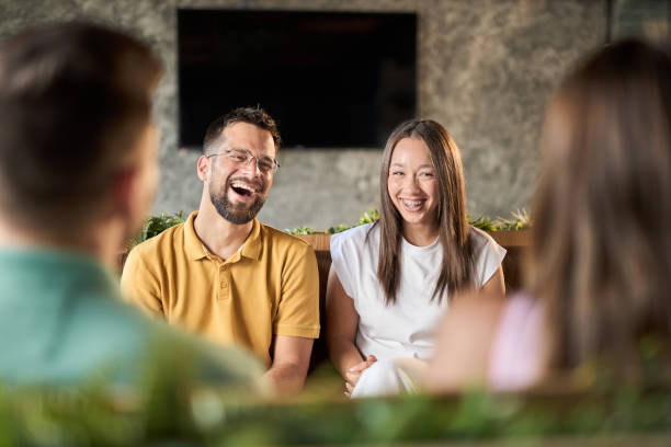 istock Group of happy couples talking while having a social gathering in a cafe 2168607439