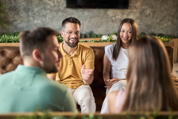 istock Group of happy couples talking while having a social gathering in a cafe 2168608507