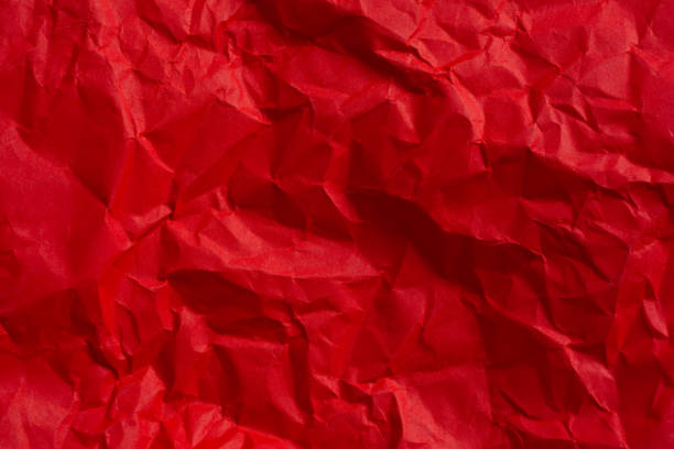 istock Wrinkled red paper texture,Rectangular crumpled sheet of red paper on a white isolated background 2168609183