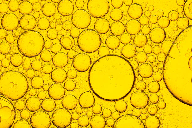 istock Yellow macro bubble texture. Different colored bubbles of oil and water. 2168609203