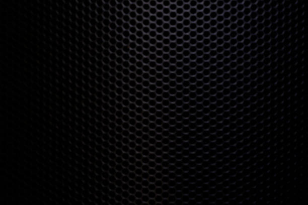 Black macro speaker surface,Fragment of the speaker with a metal perforated grille. Great background for advertising and design