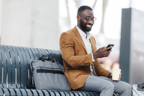 istock Well dressed man using a phone at railway station 2168610744