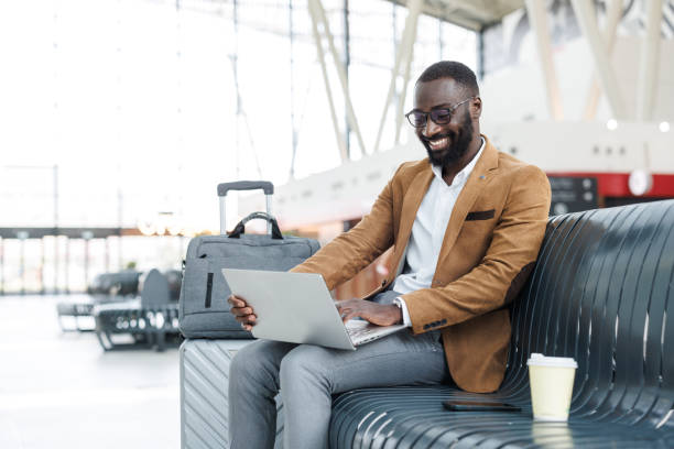 istock Businessman working on a laptop in a train station lobby 2168610950