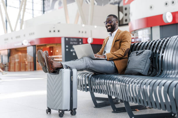 istock Businessman working on a laptop while waiting a train at the station 2168610951