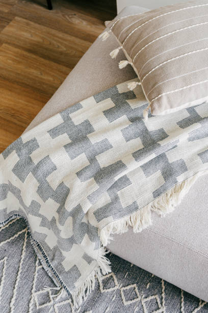 Gray and white blanket on couch or soft armchair