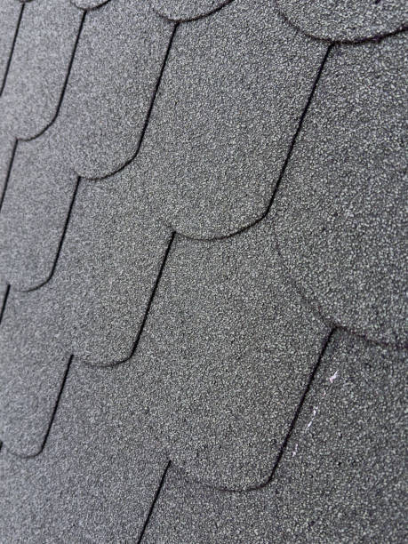 istock Close-up view of textured asphalt shingles on a roof 2168613863