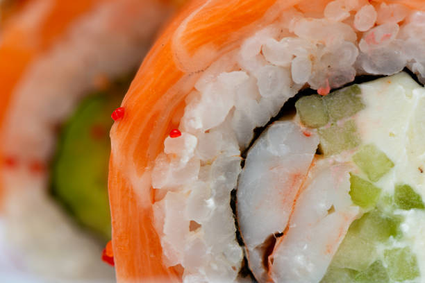 Sushi rolls close-up with rice, pickles and shrimps