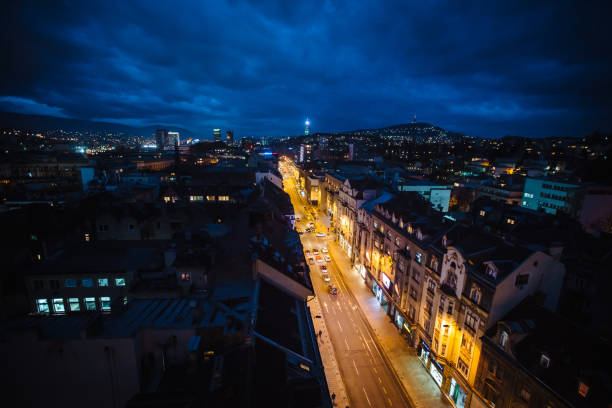 A mesmerizing night view of Sarajevo's vibrant streets, captured from above, where the city's lights weave a tapestry of culture and history