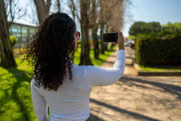 istock Woman in public square using cell phone 2168619871