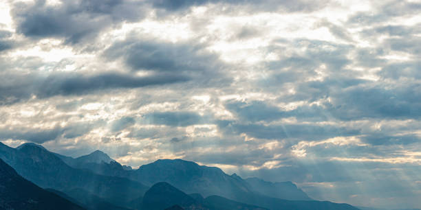 A vivid panorama of tumultuous storm clouds, featuring dark, swirling formations and a dramatic sky. This scene conveys the intense and dramatic atmosphere of severe weather conditions. Mountains Antalya Turkey. Texture background.