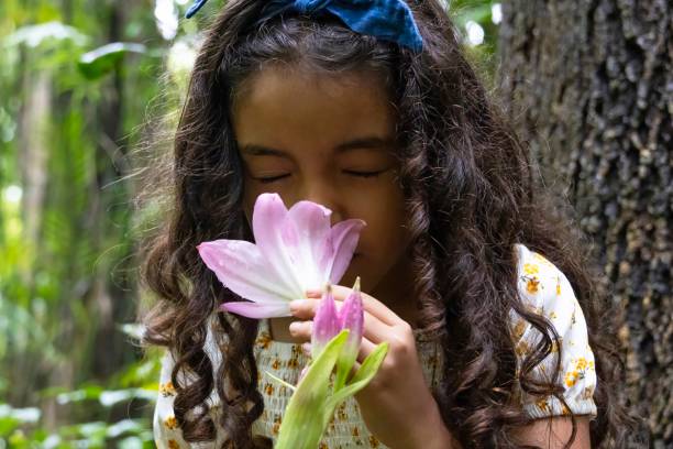 istock Girl smelling a lily flower 2168623810
