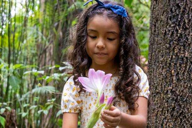 istock Girl admiring a lily flower 2168624007