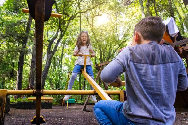 istock Brothers playing on the seesaw 2168625373