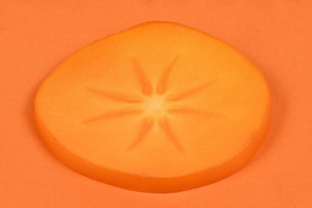 Orange ripe persimmon. Persimmon fruit. Orang fruits slice cut out. High resolution photo. Full depth of field.
