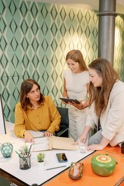 istock Business team discussing charts on a tablet in a modern office 2168626781