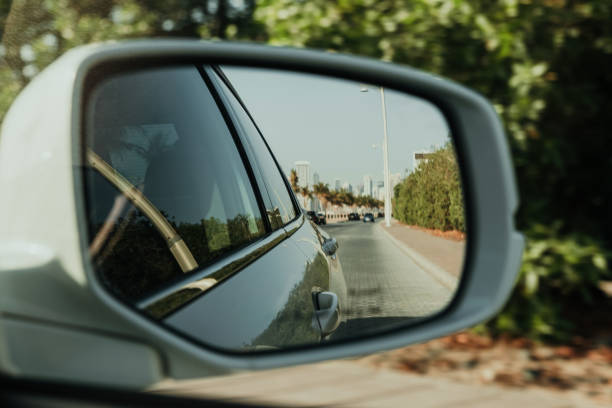 istock Car side mirror reflection with suburban area in the background 2168626839