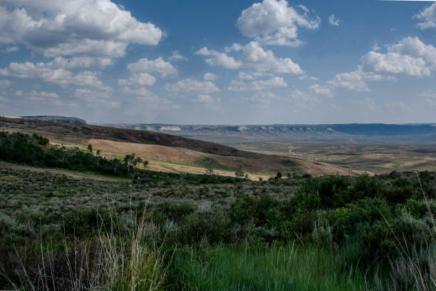 Fossil Butte National Monument, set within Wyoming's unique landscape, features Dynamic Lake nestled in the valley, surrounded by striking geological formations and natural beauty.