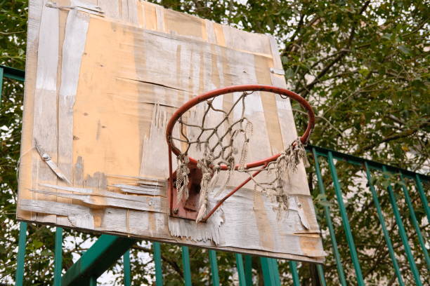istock Abandoned, damaged and unused basketball backboard. Basket with torn net. 2168629276