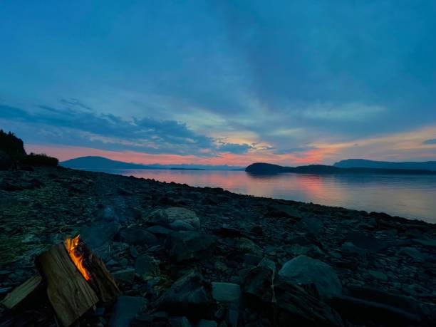 istock Colorful sunset on beach with rocks and fire 2168630576