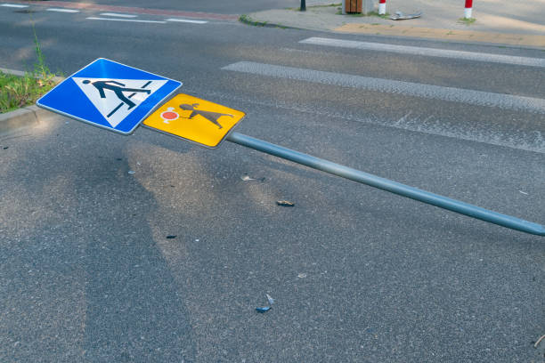 A fallen pedestrian and children's crossing sign. Accident. Traffic violation.