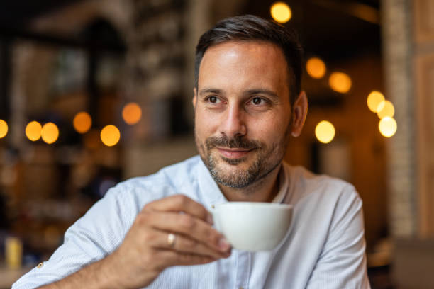istock Handsome elegant man enjoying a cup of coffee 2168636581