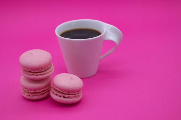 istock Pink Macarons and Black Coffee on Pink Background 2168636709