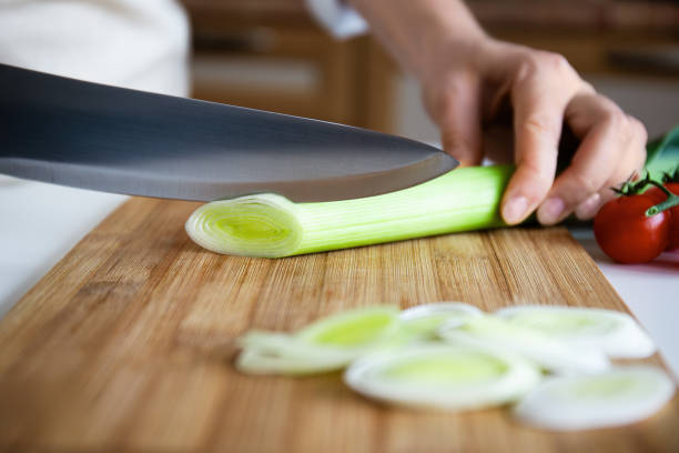 istock Chopping Fresh Leek on Wooden Board 2168640384