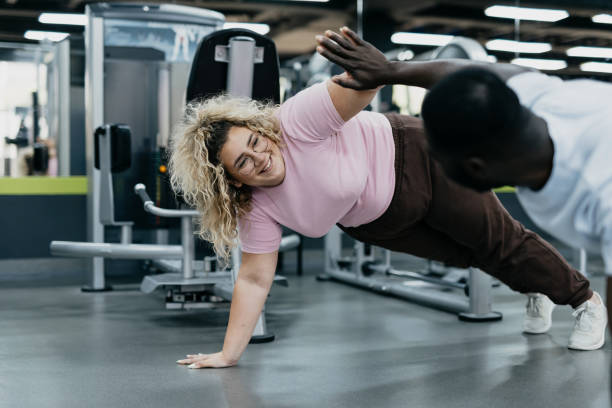 istock Two individuals engaged in a high-five during plank workout 2168645376