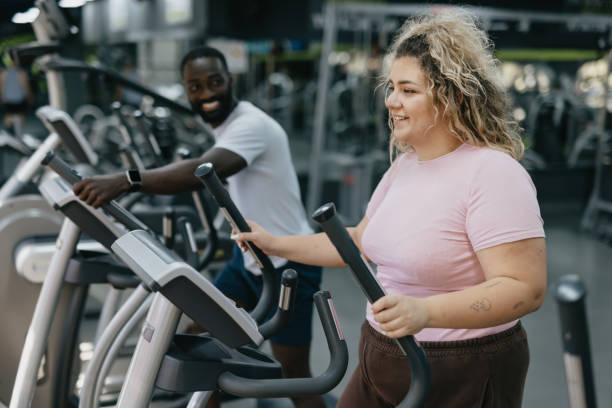istock Woman and trainer using elliptical machines at the gym. 2168645503