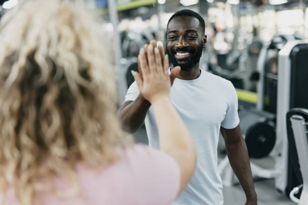 istock Trainer and woman high-five after gym workout session. 2168645597