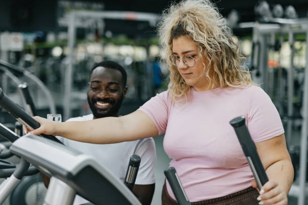 istock Gym session guidance on the elliptical machine, focus 2168645731