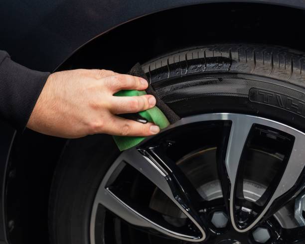 istock A master is blackening car tires in a garage. 2168646272