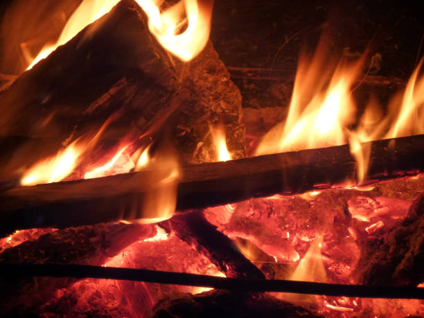 Red burning embers from a tree in a fire close-up full frame
