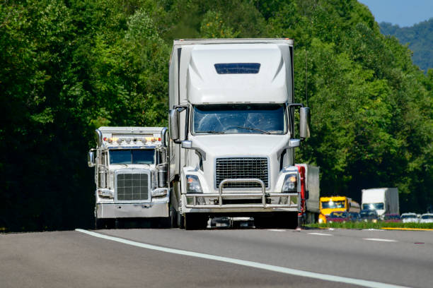 istock Two White Semis Lead A Long Row of Interstate Travelers 2168653022