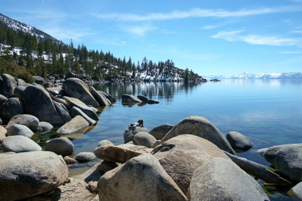 Beautiful smooth boulders line the shores of Lake Tahoe on a sunny day in early spring.