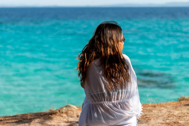 istock Young woman on the beach 2168655835