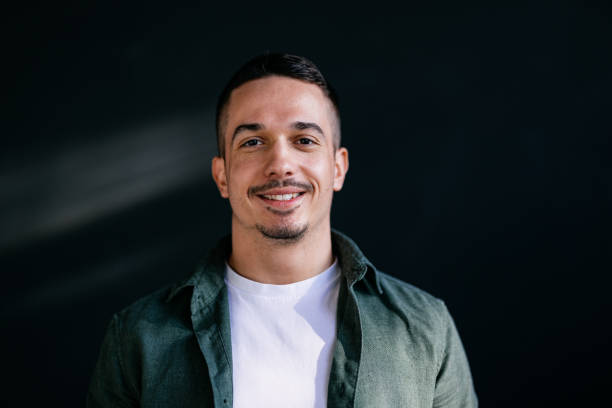 istock Confident Young Man Smiling Against Dark Background 2168660258