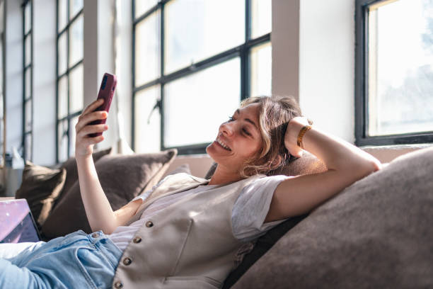 istock Relaxed Woman Enjoying Her Smartphone on a Sunny Day 2168660283