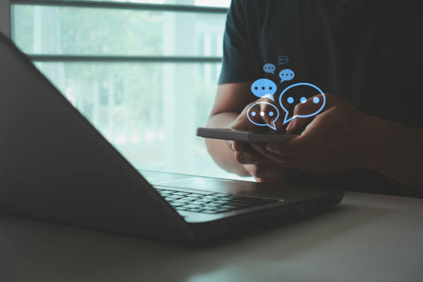 istock Live chat chatting and social network concept. Businessman hand using smartphone typing, chatting conversation in chat box icon pop up. Digital online communication, social media marketing technology 2168660482